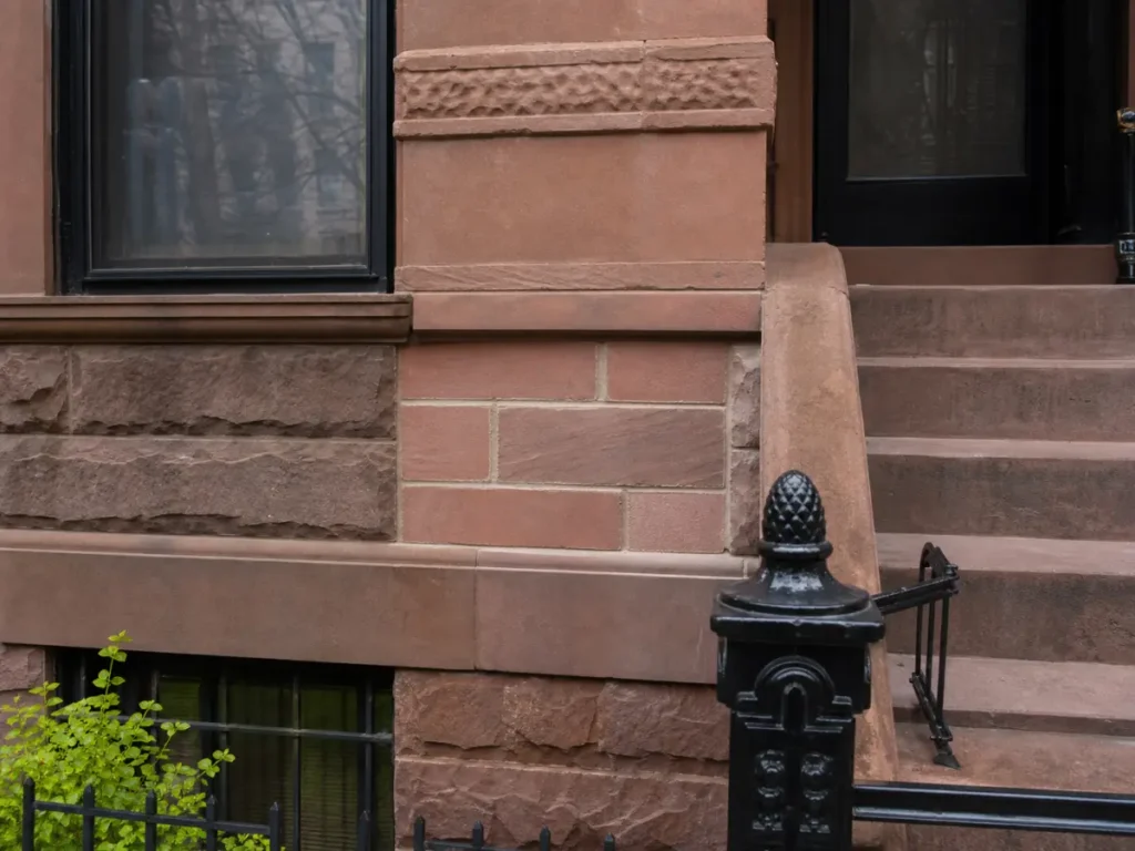 Historic brownstone facade repair with carefully matched masonry and mortar