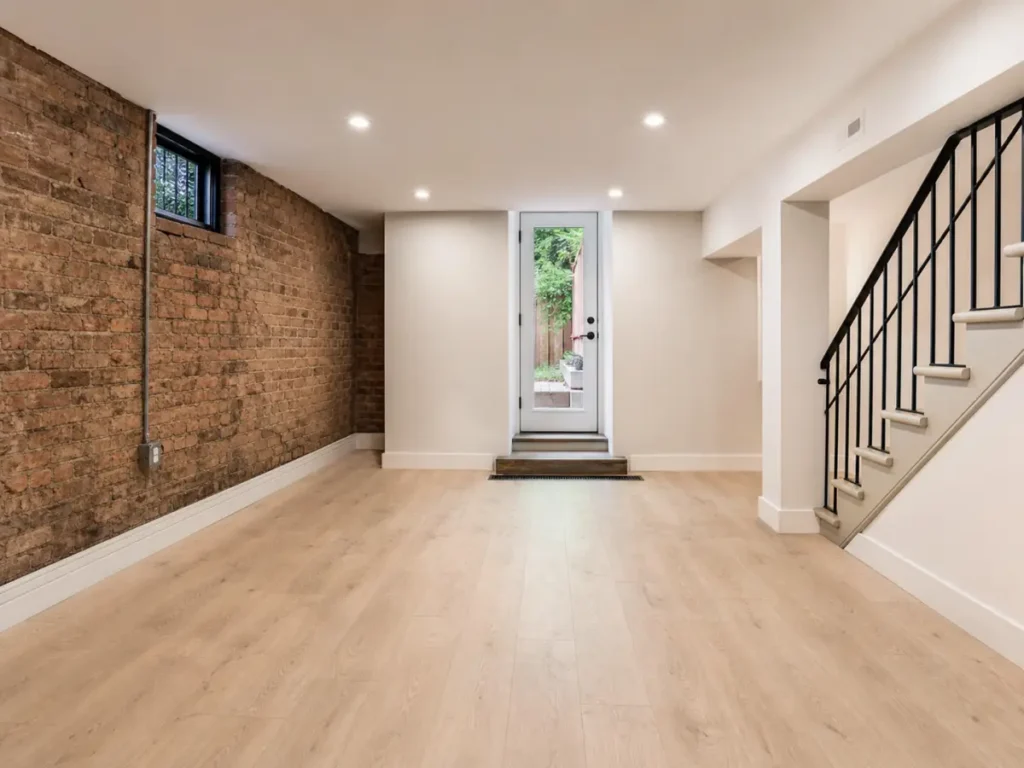 Dry renovated brownstone garden level with rear egress and exposed brick