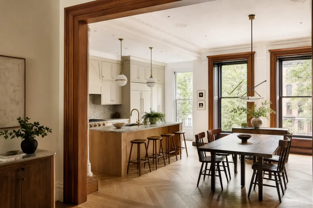 Renovated Carroll Gardens brownstone parlor kitchen and dining room with restored woodwork and custom cabinetry