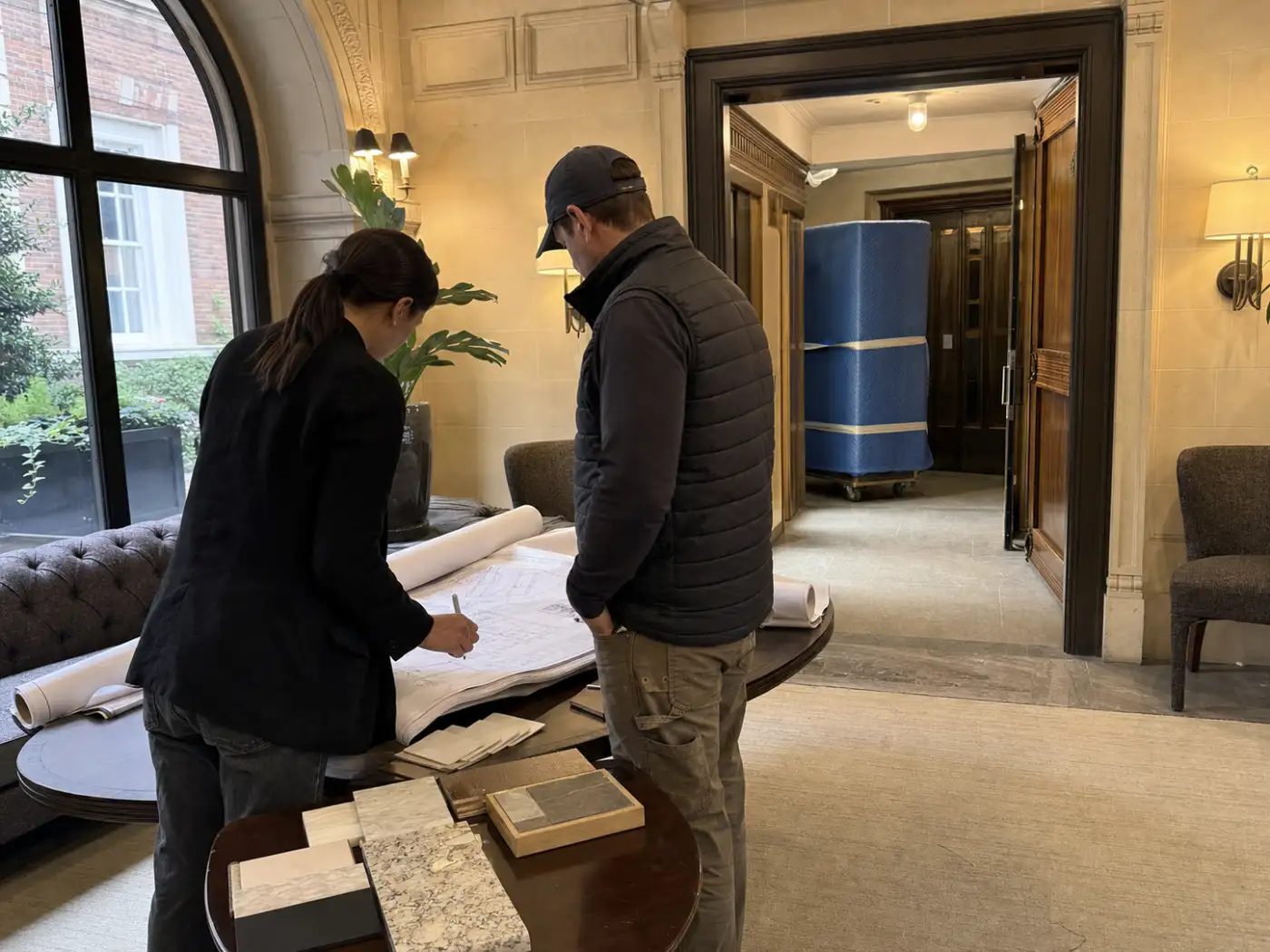 Architect and contractor coordinating renovation drawings in a Manhattan pre-war co-op building