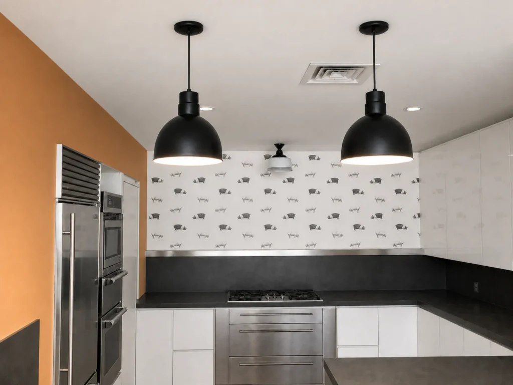 Completed East 17th Street Manhattan loft kitchen with crisp white cabinetry, dark counters, and pendant lighting