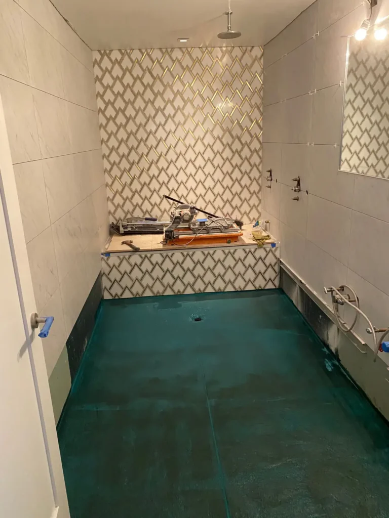 Bathroom floor and shower transitions covered with waterproofing before tile installation