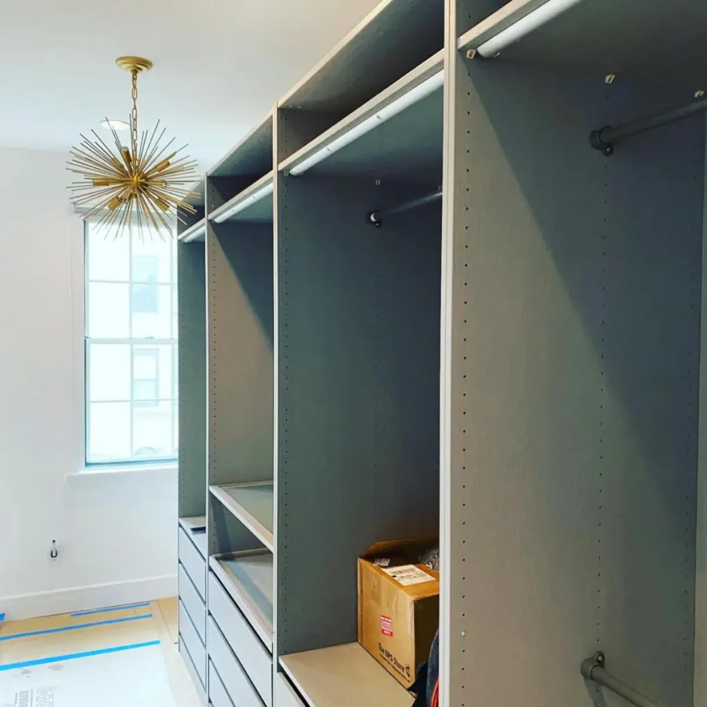 Full-height dark wardrobe storage installed along a Williamsburg bedroom wall