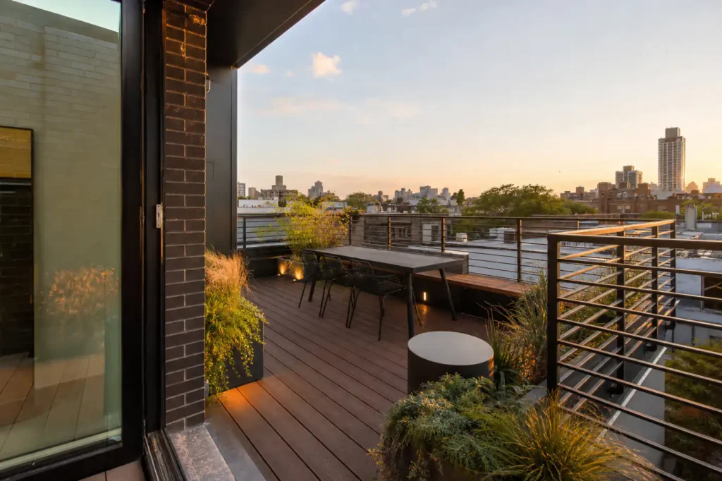 Williamsburg private rooftop renovation with wood decking, code-compliant railings, planters, and integrated lighting